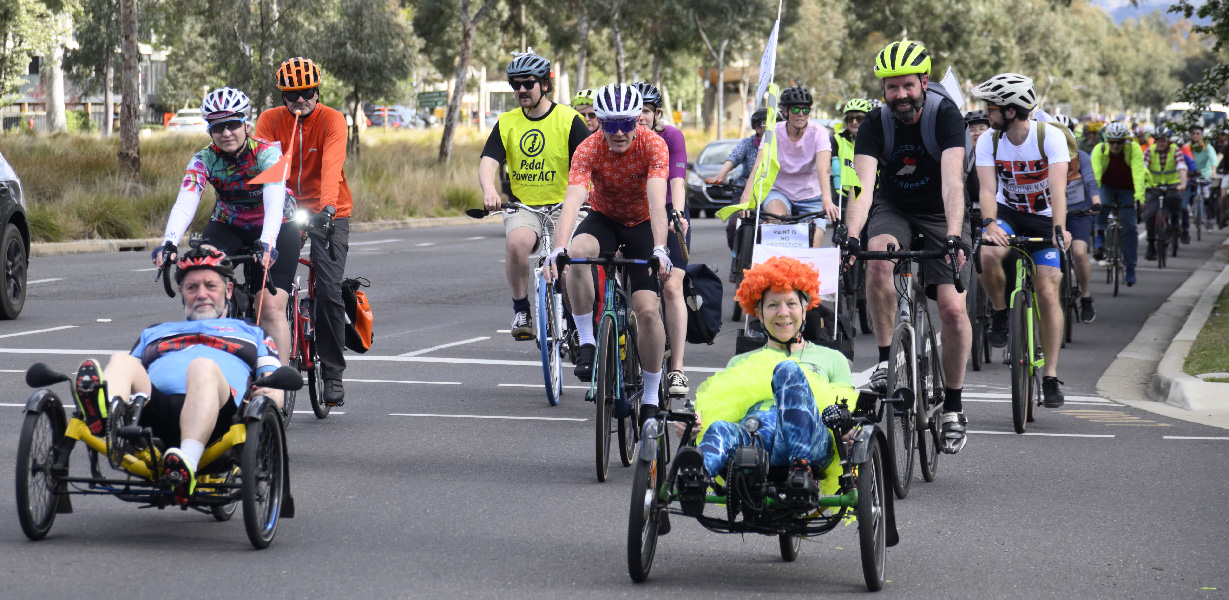 Two recumbent trikes leading cyclists